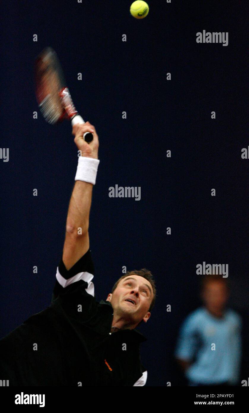 Jean-Claude Scherrer serves a ball during the match between Switzerland's  George Bastl and Switzerland's Jean-Claude Scherrer against Australia's Paul  Hanley and Zimbabwe's Kevin Ullyett at the Davidoff Swiss Indoors tennis  tournament in
