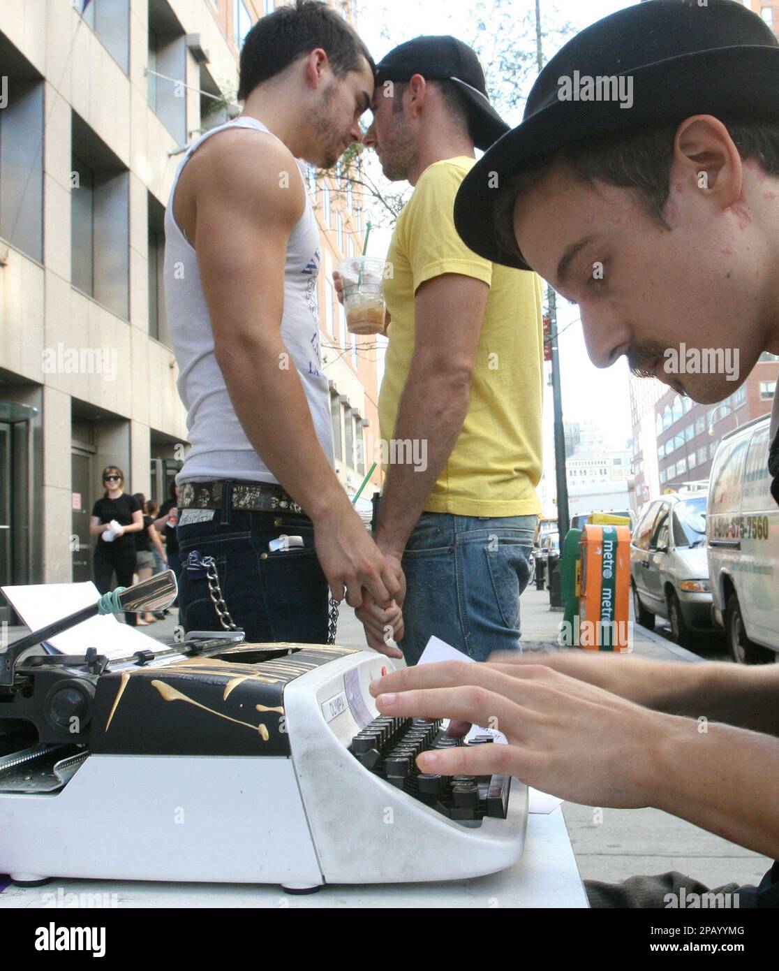 Garrett Montoya, left, and his boyfriend Jayson Crane hold hands as