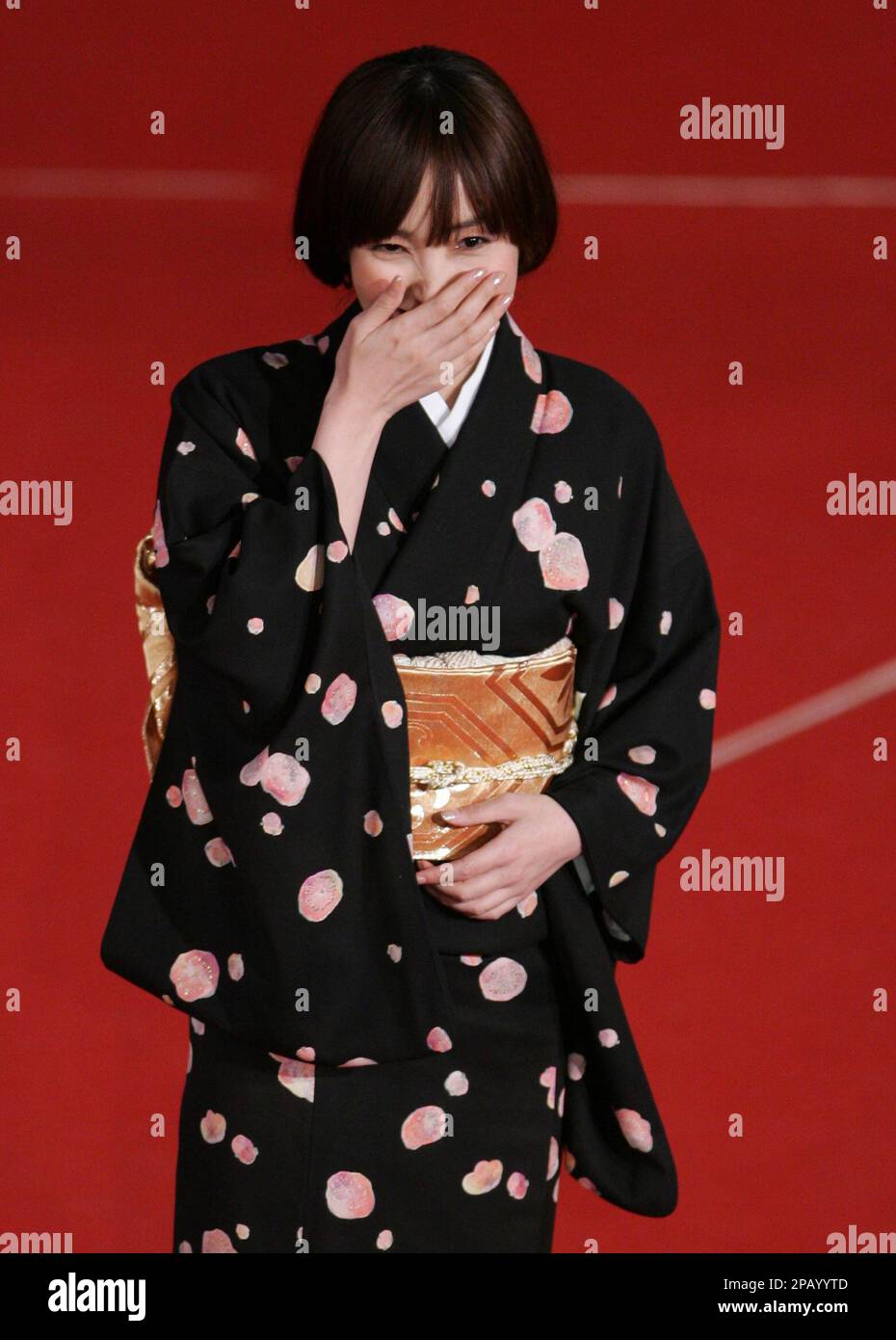 Japanese actress Kumiko Aso smiles on the red carpet for the screening