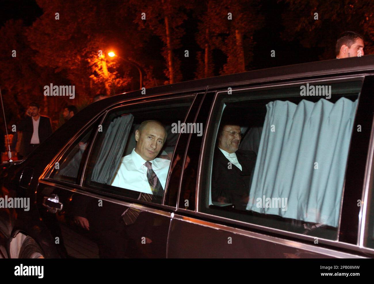 Russian President Vladimir Putin, left, and Iranian FM Manouchehr Mottaki,  sit in a limousine after they attended an official departure ceremony for  Putin in Tehran, Iran, Tuesday, Oct. 16, 2007. (AP Photo/Hasan