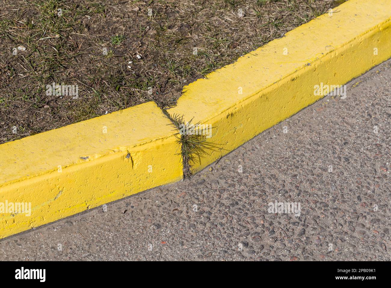 Yellow curb stone border and asphalt road Stock Photo Alamy