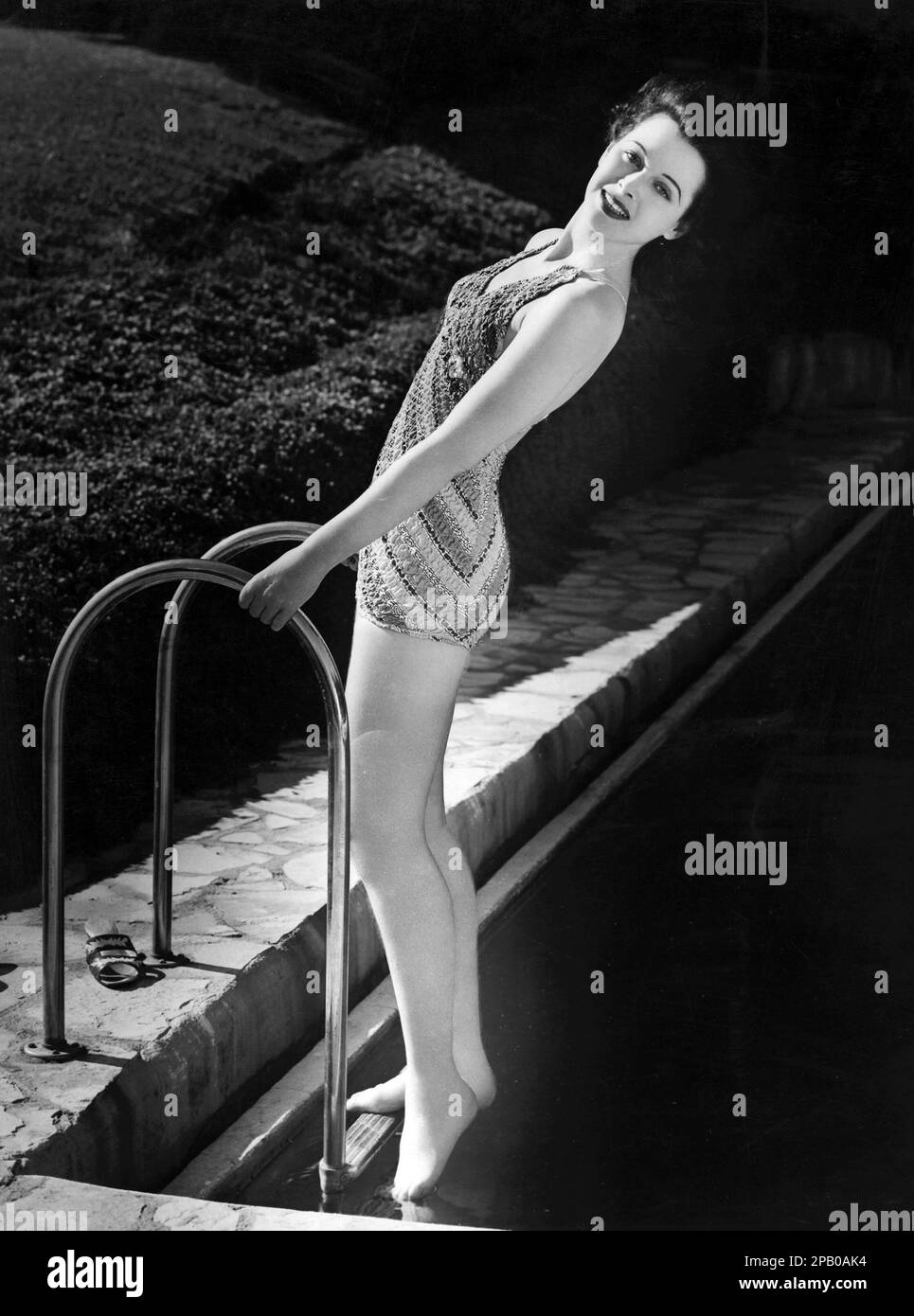 Hedy Lamarr in a swim suit by the pool, publicity photo (1938). Portrait Photo Stock Photo