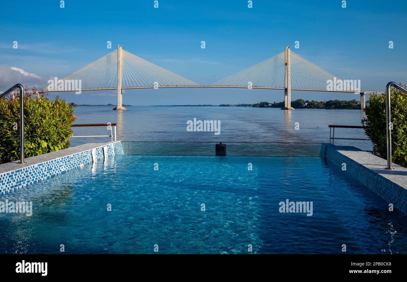 A view of the Tsubasa Bridge across the Mekong River in Kandal Province, Cambodia from the stern of the river cruise ship Victoria Mekong. Stock Photo