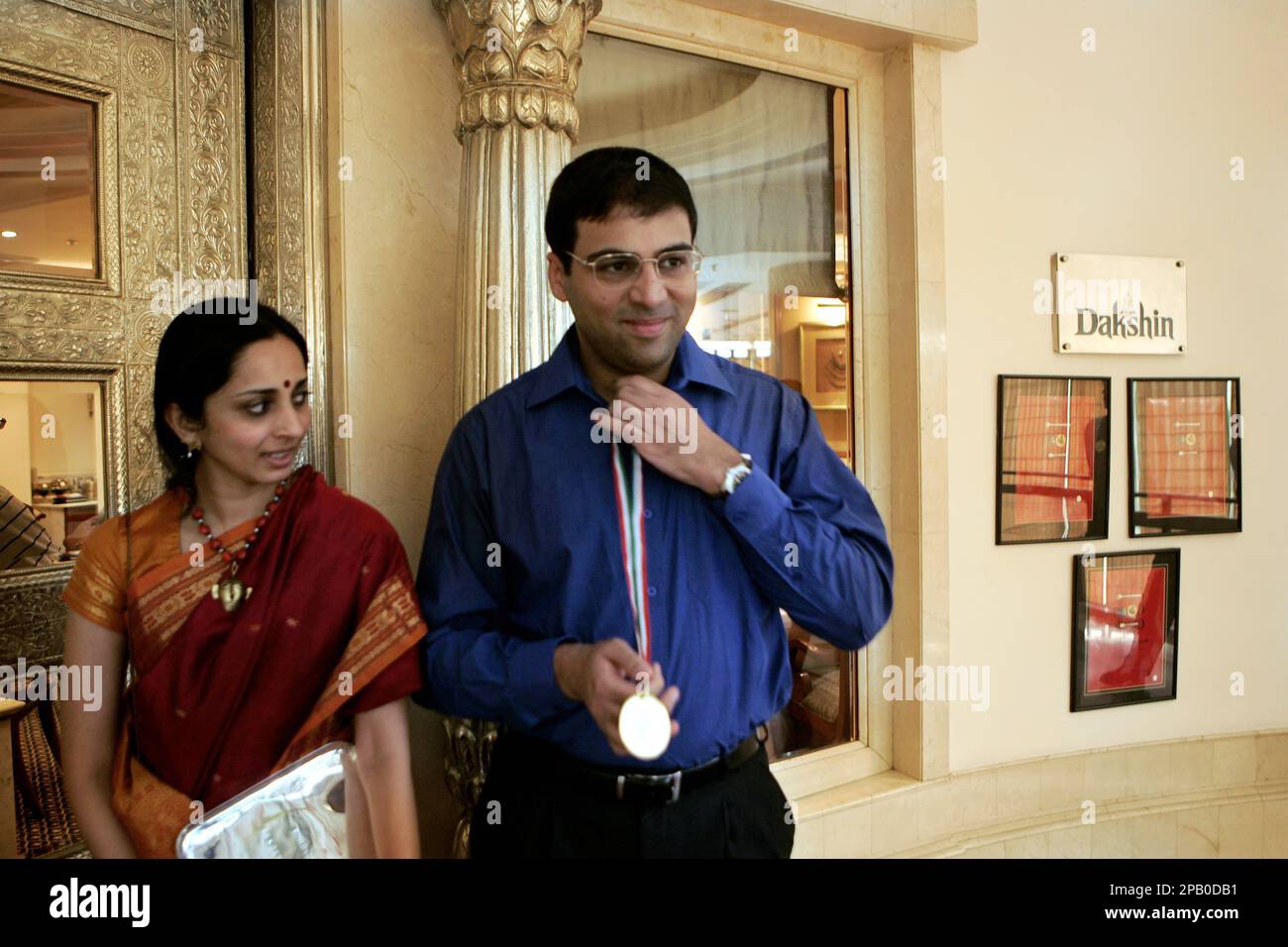 Aruna Anand, wife of Indian chess grandmaster Viswanathan Anand, right,  gives him a piece of cake during her birthday celebrations in Gauhati,  India, Thursday, June 30, 2005. (AP Photo/Anupam Nath Stock Photo 