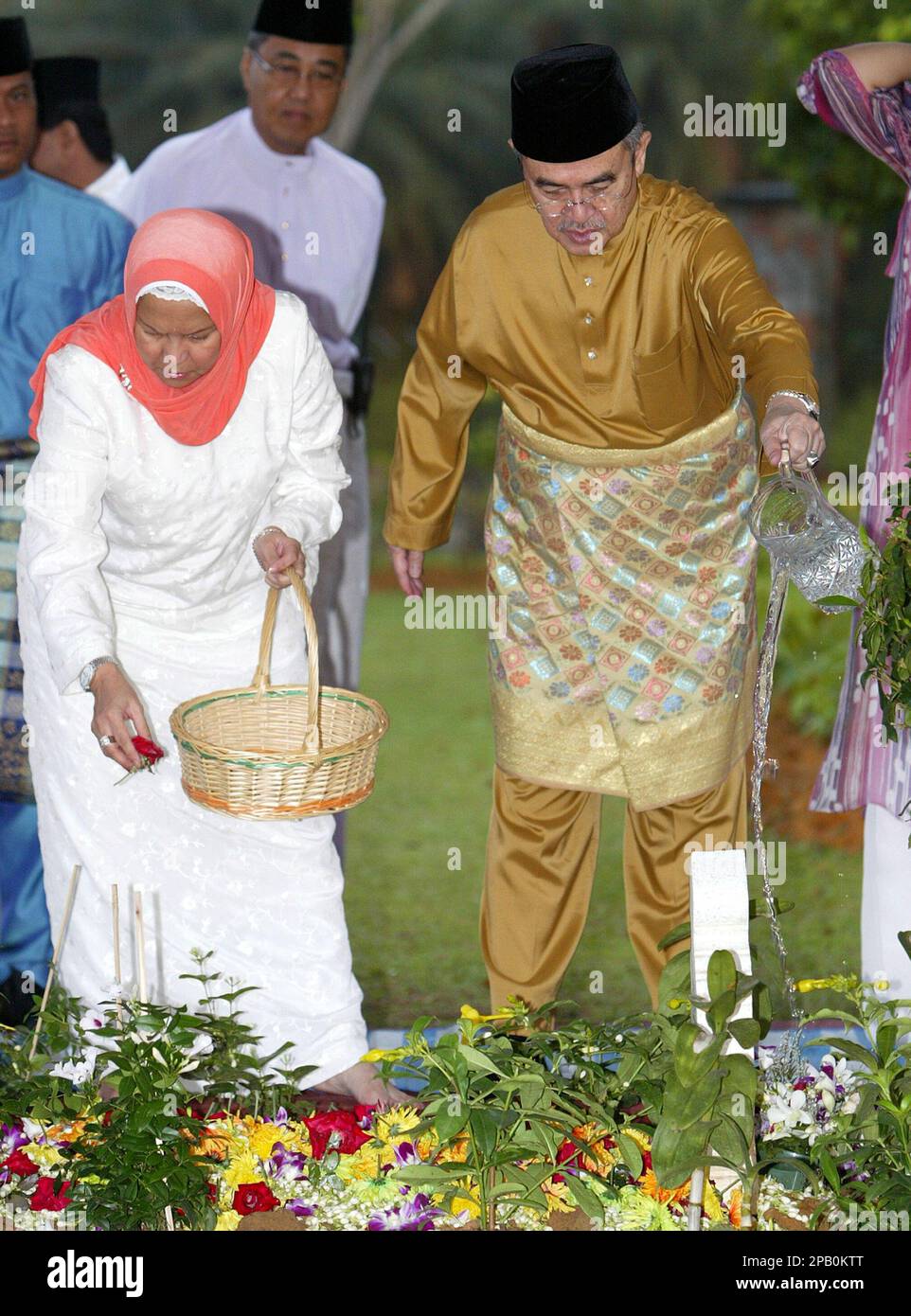 Malaysian Prime Minister Abdullah Ahmad Badawi pours water on his first