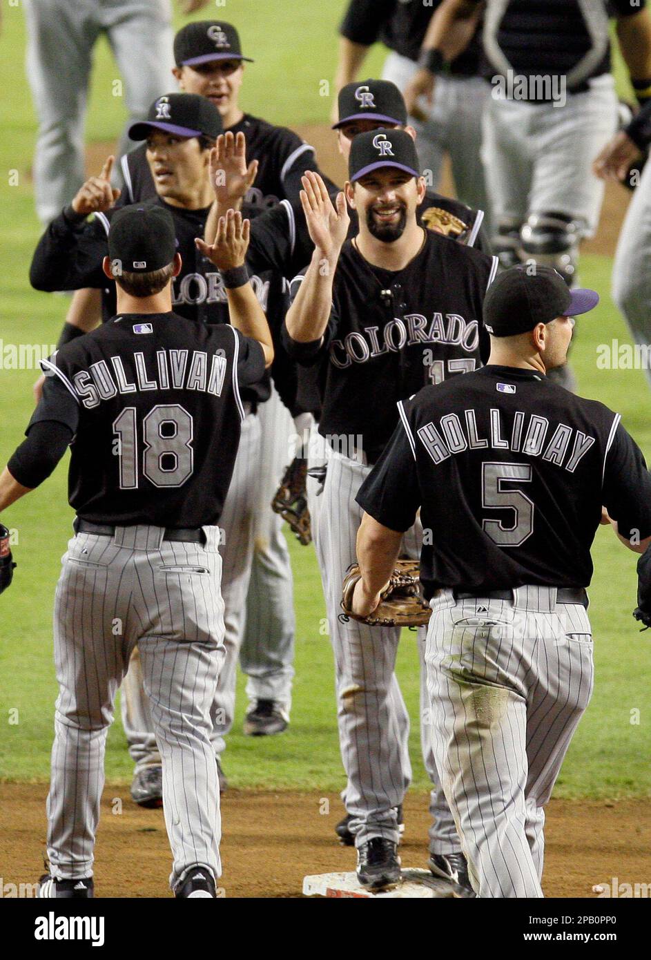 From left, Colorado Rockies' Todd Helton celebrates with Matt