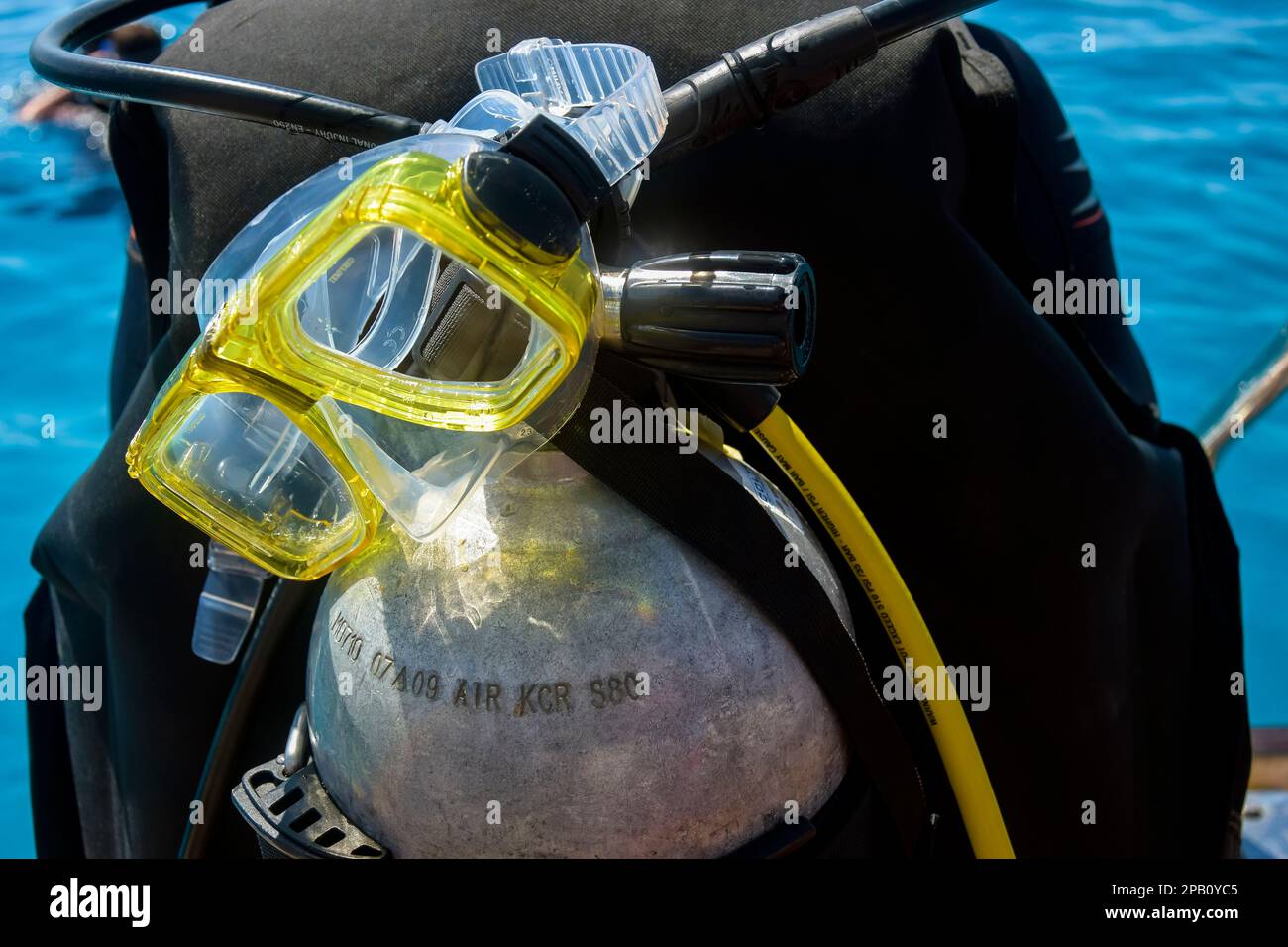 Scuba diver before diving. Diving lesson in open water. Male in scuba diving suit is preparing