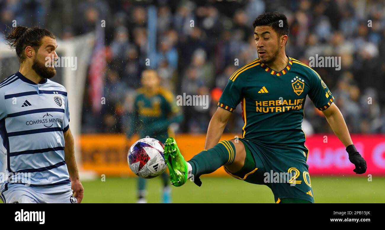Kansas City, USA. 11th Mar, 2023. Los Angeles Galaxy midfielder Memo Rodríguez (20) settles the bball as Sporting Kansas City midfielder Graham Zusi (8) watches. Sporting KC hosted the LA Galaxy in a Major League Soccer game on March 11, 2023 at Children's Mercy Park Stadium in Kansas City, KS, USA. Photo by Tim Vizer/Sipa USA Credit: Sipa USA/Alamy Live News Stock Photo