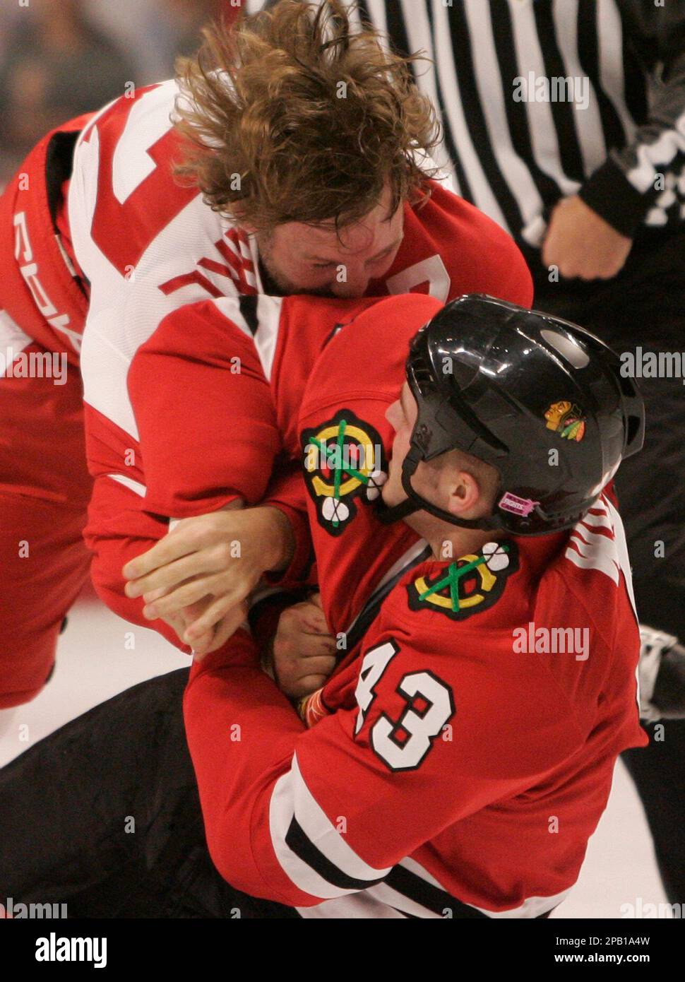Detroit Red Wings' Dallas Drake, top, tackles Chicago Blackhawks' James