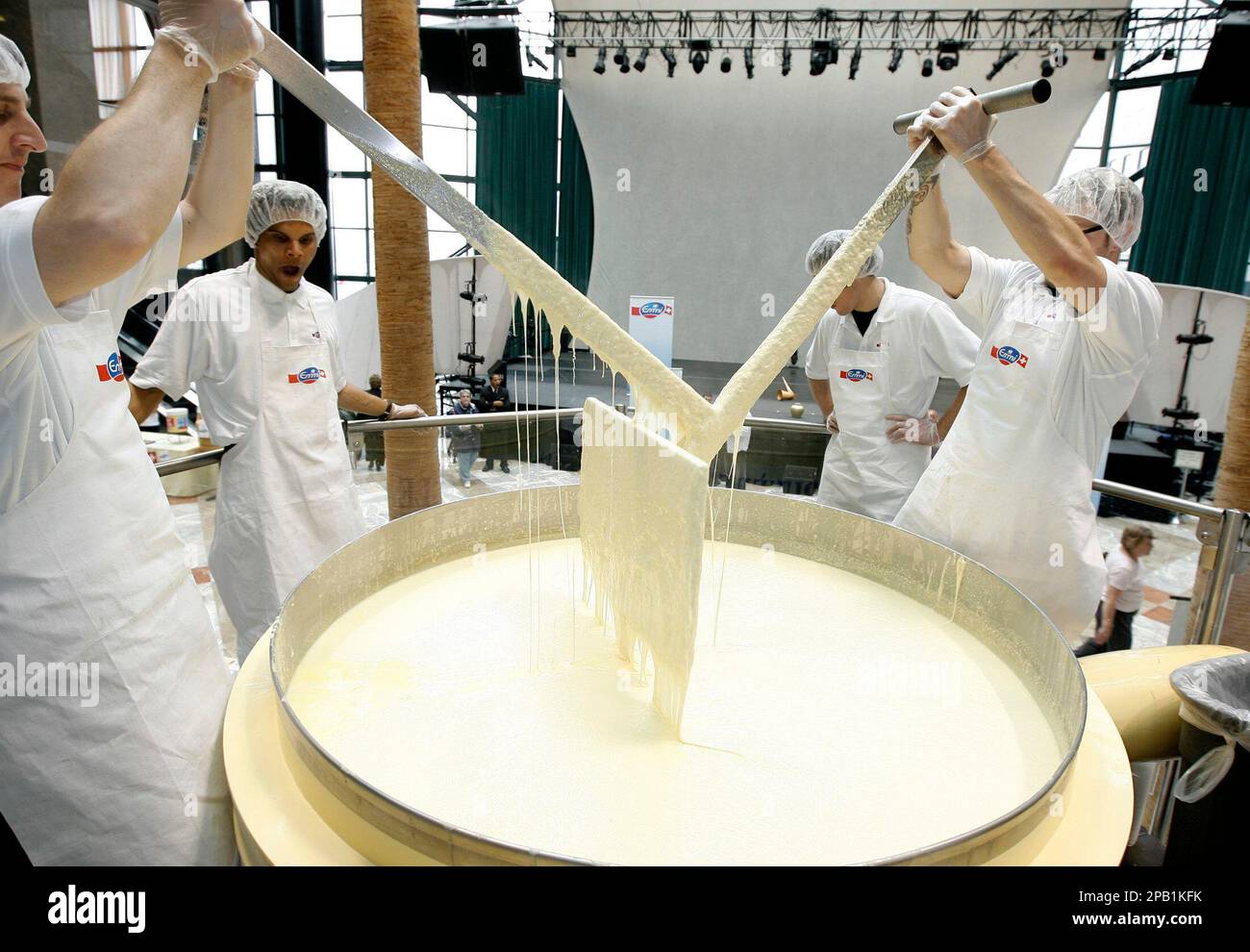 Emmi workers stir some of the 1300 Kilograms of Swiss fondue cheese