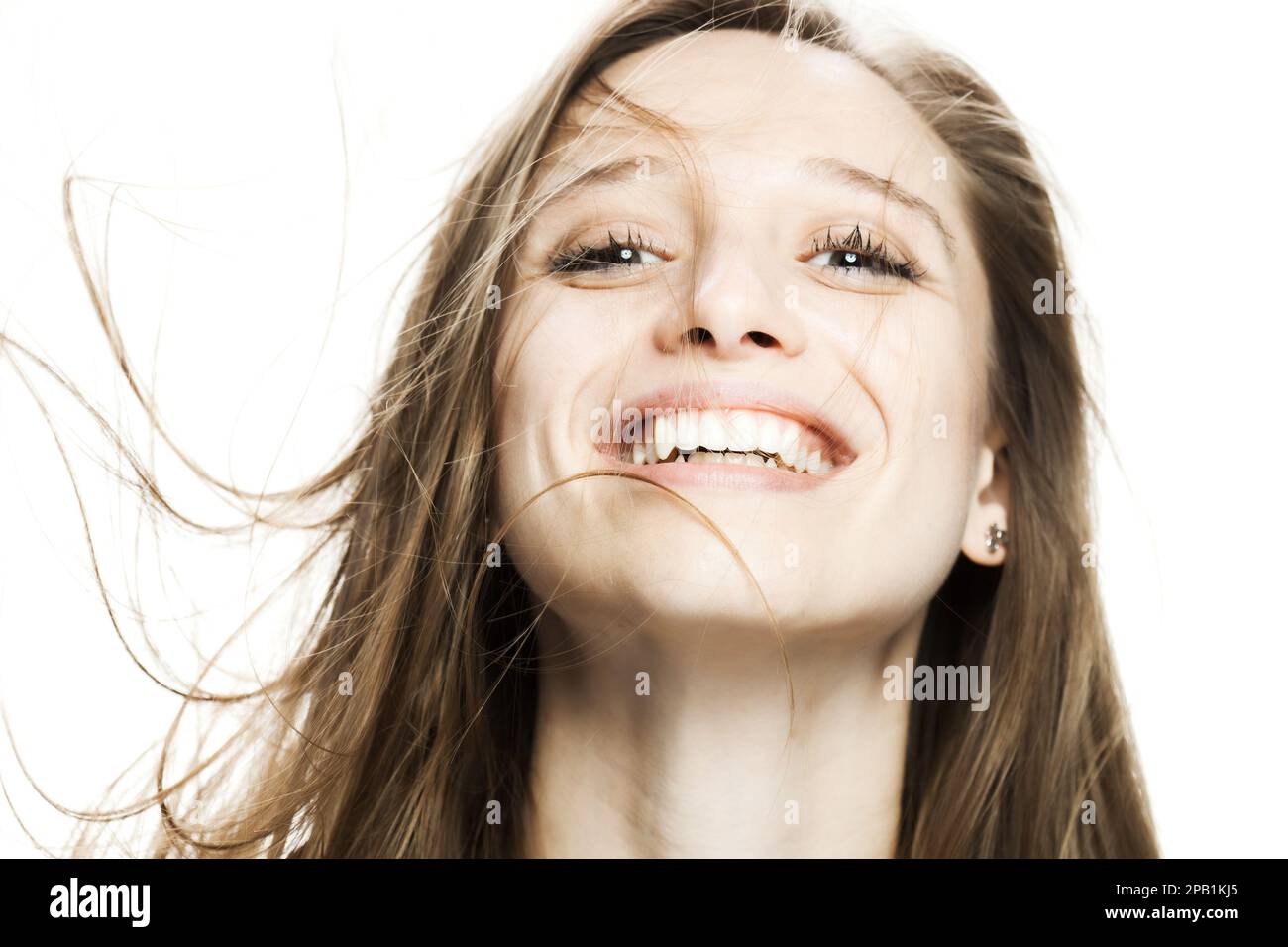 girl with flowing hair in the air studio portrait against