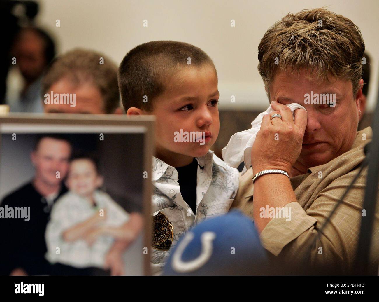 Sheila Phillips, mother of miner Brandon Phillips who was killed in the  Crandall Canyon mine in Utah, wipes away a tear as her grandson, Gage  Phillips, 5, looks on during a House