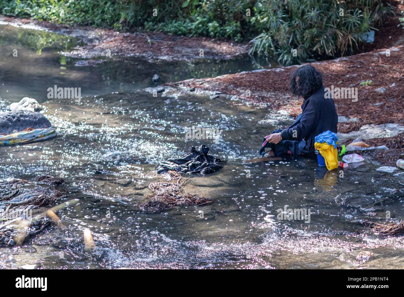 Zapopan, Jalisco Mexico. January 1, 2023. Homeless man sitting on rocks