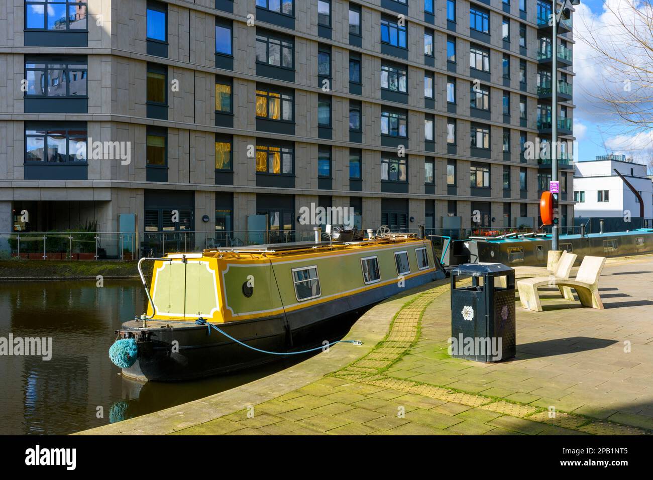 The One Vesta Street apartment block with a canal narrowboat in the foreground, New Islington, Ancoats, Manchester, England, UK Stock Photo