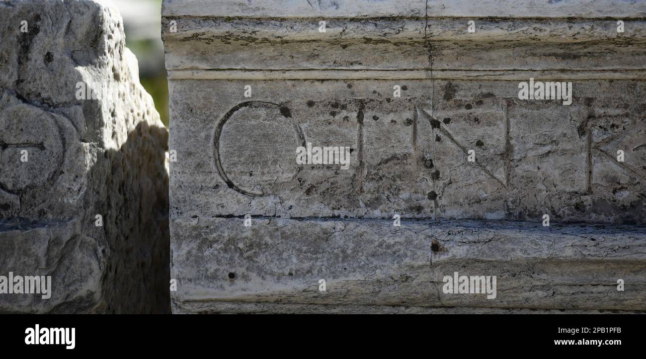 Archological Inscription Ancient Greek fragmentary marble inscription at the Archaeological site ...