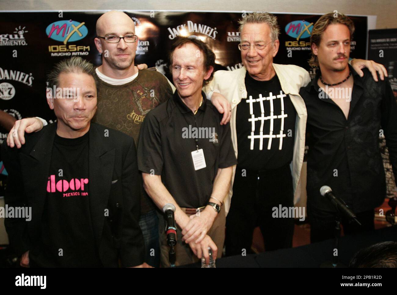 Members of the rock-band The Doors, from left, Bill Chan, Ty Dennis, Ray  Manzarek, Robby Krieger and Brett Scallions pose for photographers during a  press conference in Mexico City, Tuesday, Oct. 2,