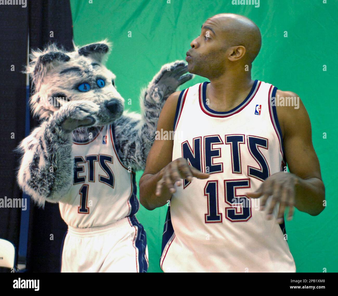 Singer Ciara is greeted by Sly, the Nets mascot, as she attended