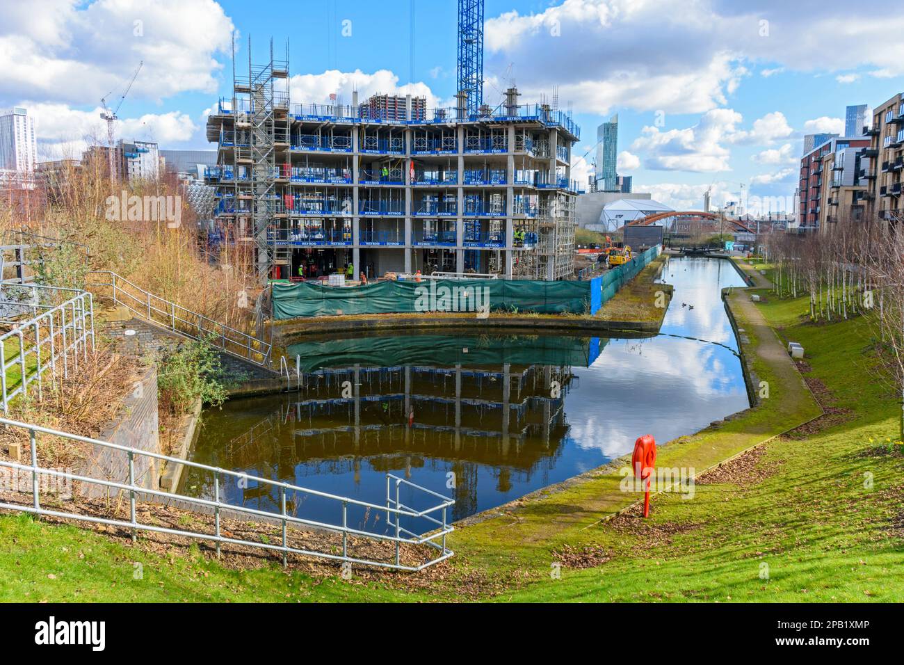 Apartments block under construction at the Middlewood Locks development, over the Manchester, Bolton and Bury Canal, Salford, Manchester, England, UK Stock Photo
