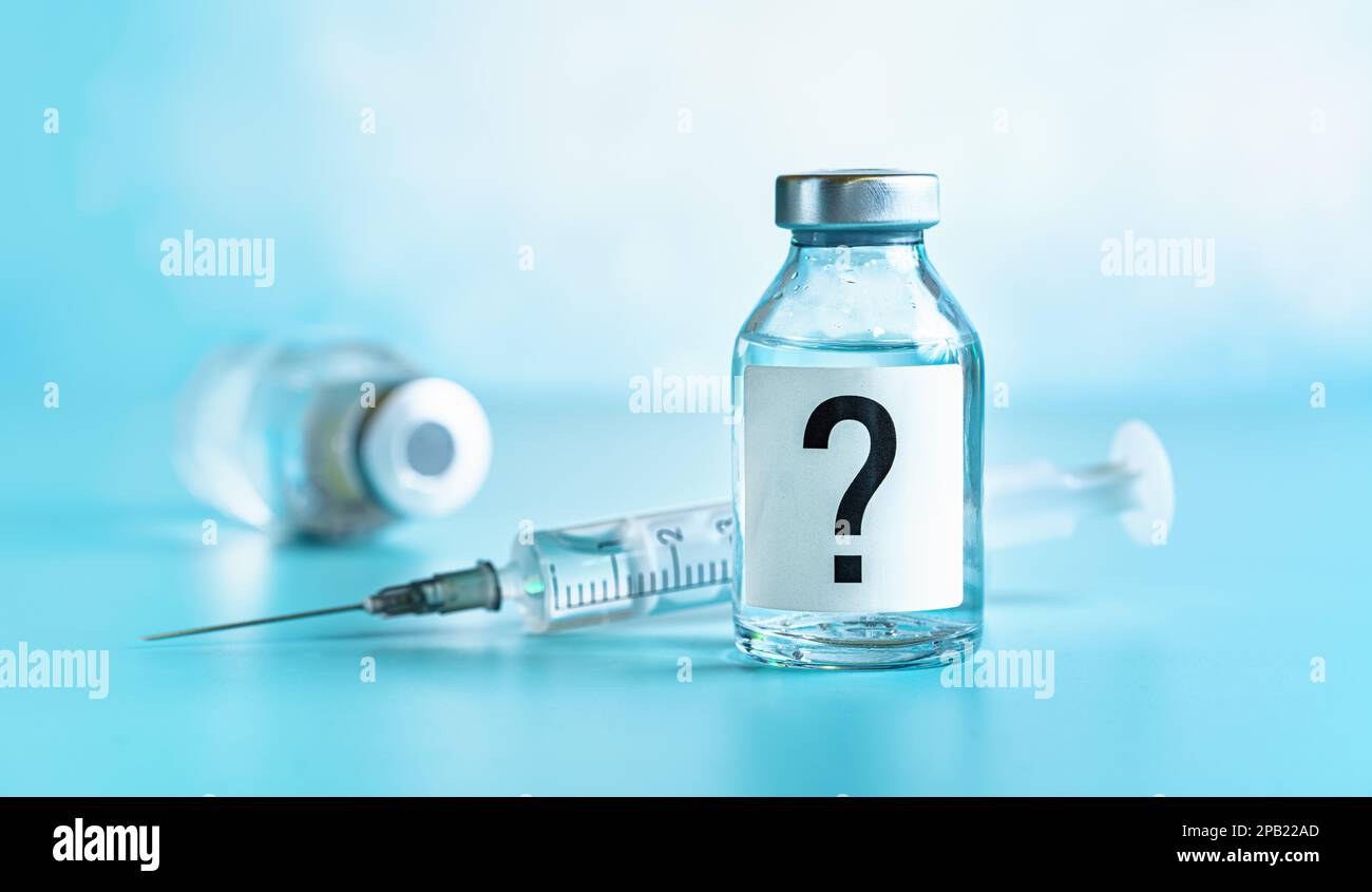 Vaccine bottle with hypodermic syringe needle near, question mark on
