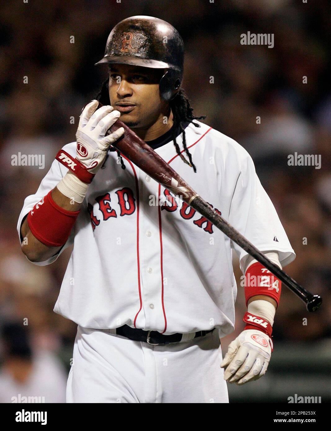 Boston Red Sox's Manny Ramirez kisses a bat as he returns to the plate from  the dug out after breaking a bat in the first inning of a baseball game  against the