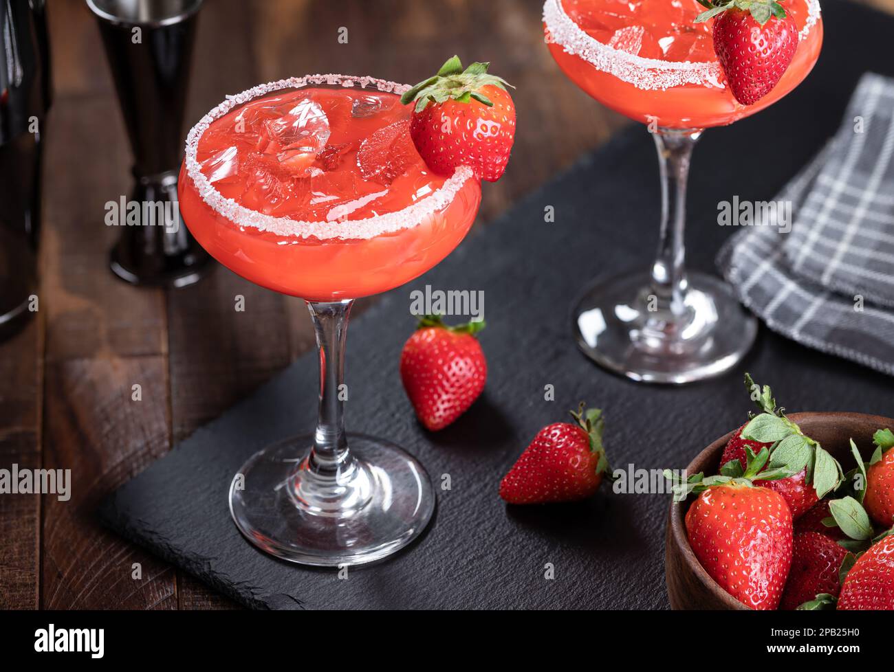 Strawberry margarita cocktail garnished with strawberries and salt rim