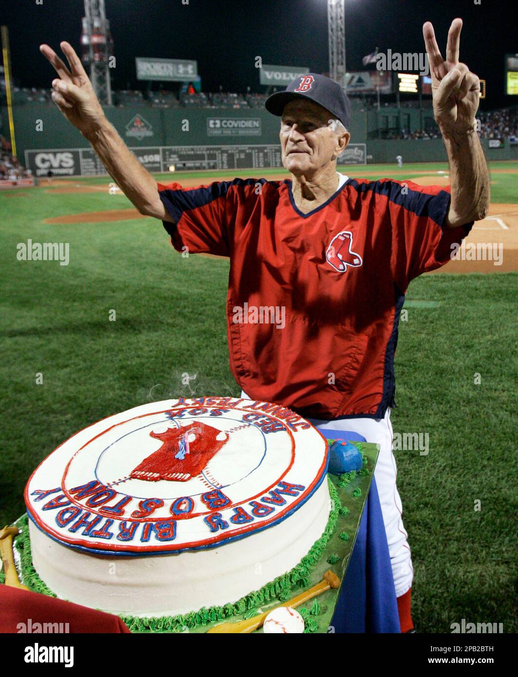 Boston Red Sox legend Johnny Pesky gestures to cheering fans as his 88th  birthday is celebrated with a cake prior to their baseball game against the  Minnesota Twins at Fenway Park in