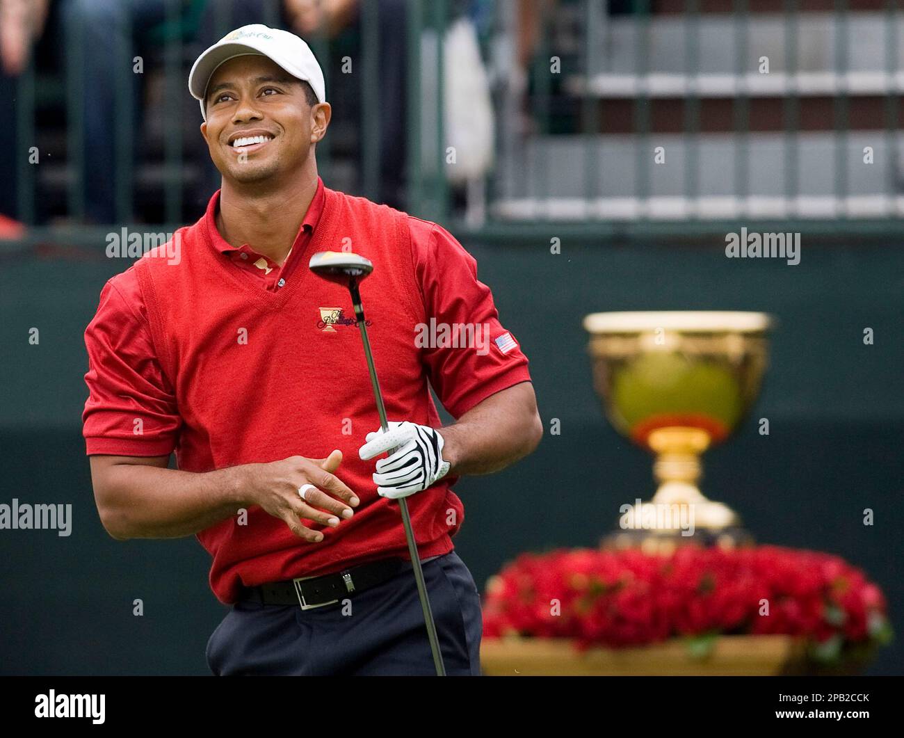 With the Presidents Cup trophy in the backround, United States team member Tiger Woods watches his drive off the first tee during first round of play at the Presidents Cup golf tournament