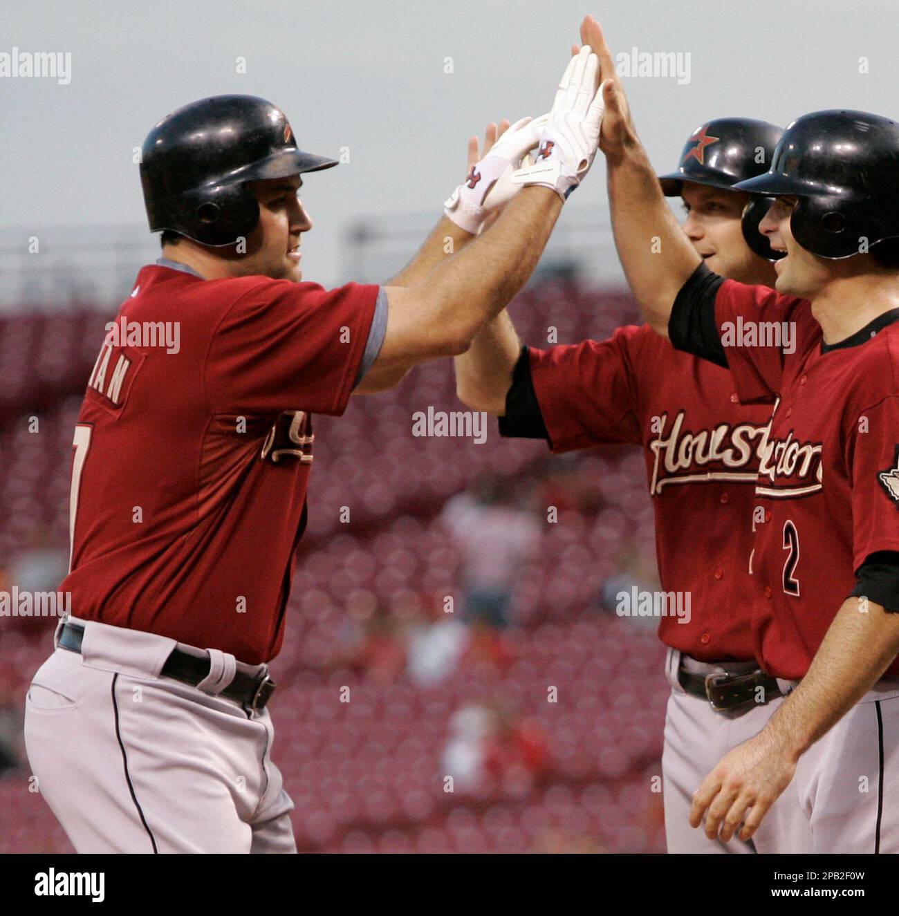 Houston Astros' Chris Burke (2) is congratulated by teammate Lance