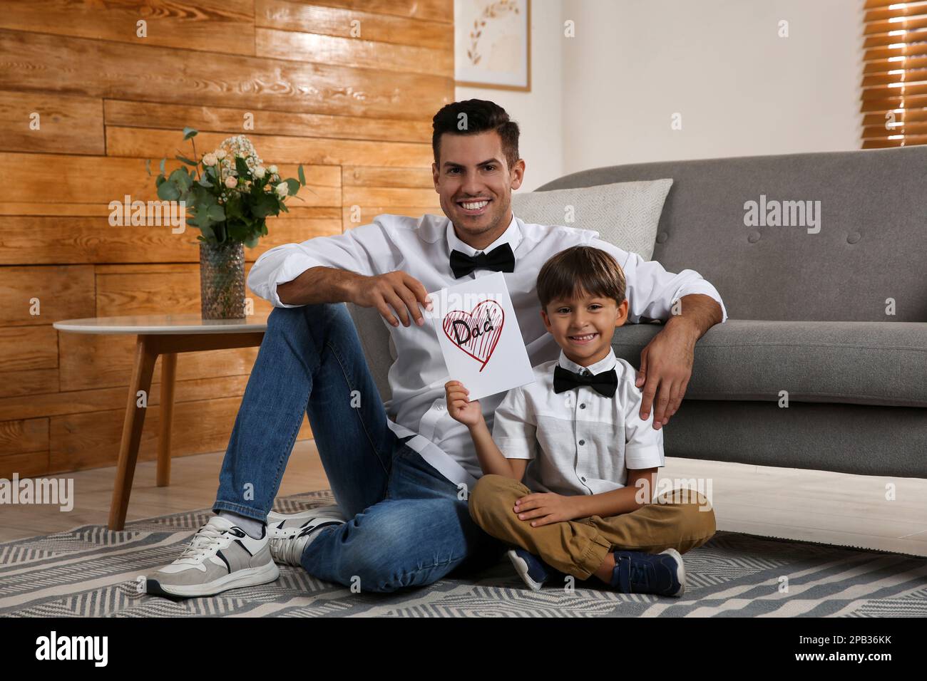 Little boy greeting his dad with Father's Day at home Stock Photo - Alamy