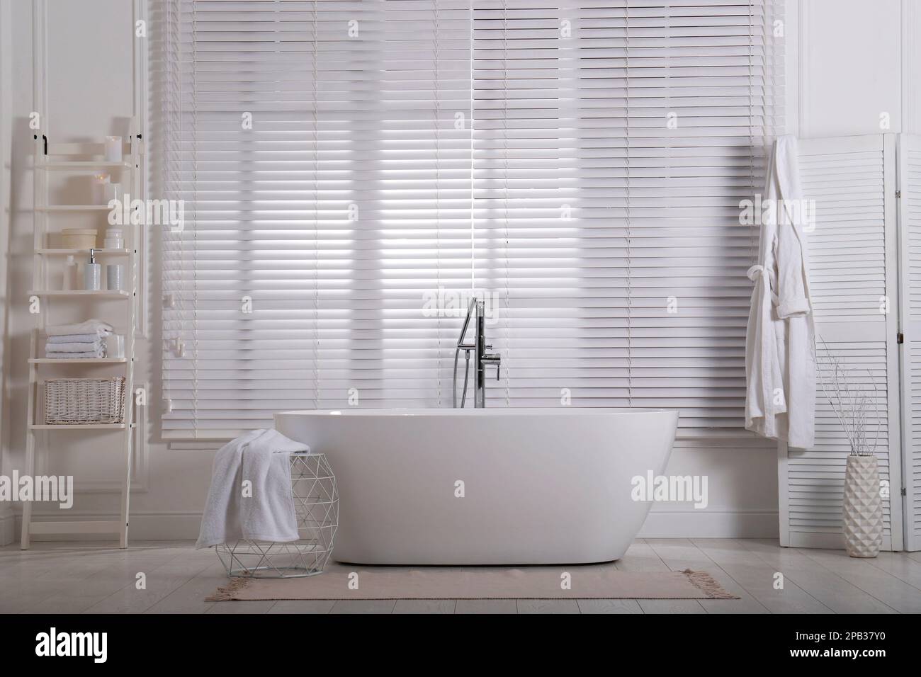 Minimal bathroom interior with modern white tub Stock Photo - Alamy
