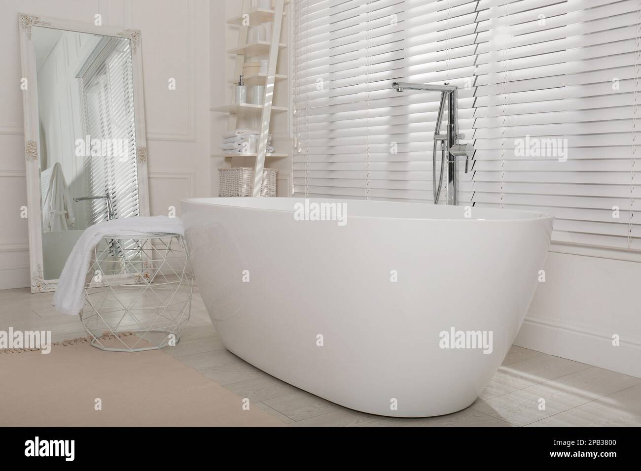 Minimal bathroom interior with modern white tub Stock Photo - Alamy