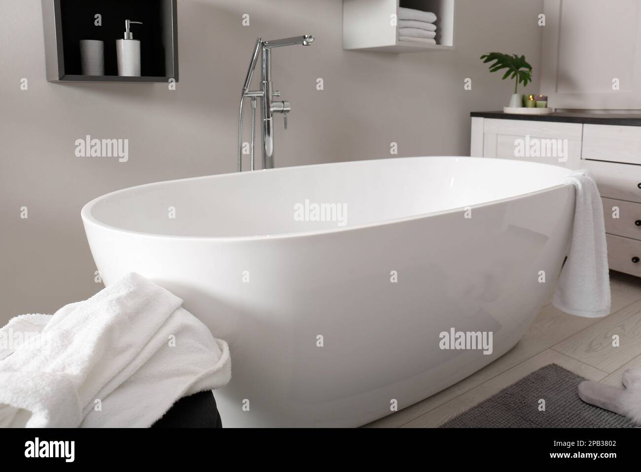Stylish bathroom interior with modern white tub Stock Photo - Alamy