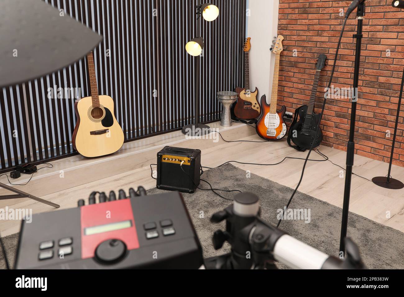 Music studio full of instruments and pc display Stock Photo - Alamy