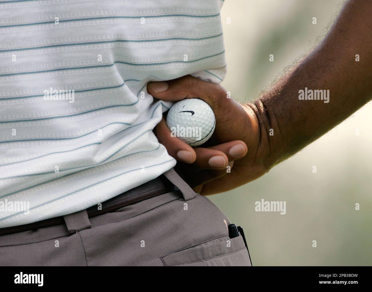 Tiger Woods holds a Nike golf ball while waiting for his turn to putt  during second round action in the Bridgestone Invitational Golf Tournament  at the Firestone Country Club in Akron, OH,