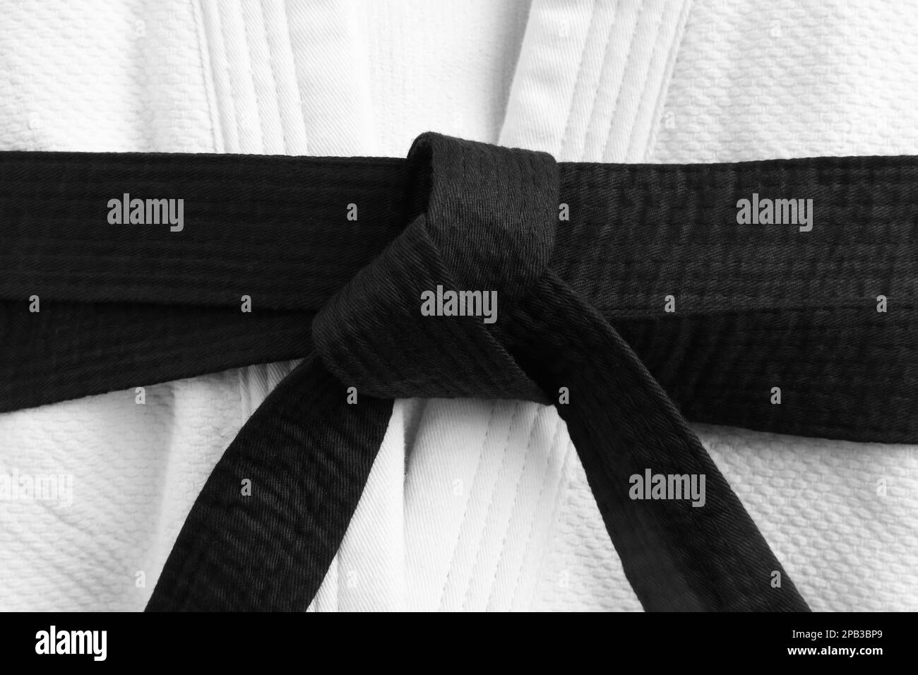 Martial arts uniform with black belt, closeup Stock Photo Alamy