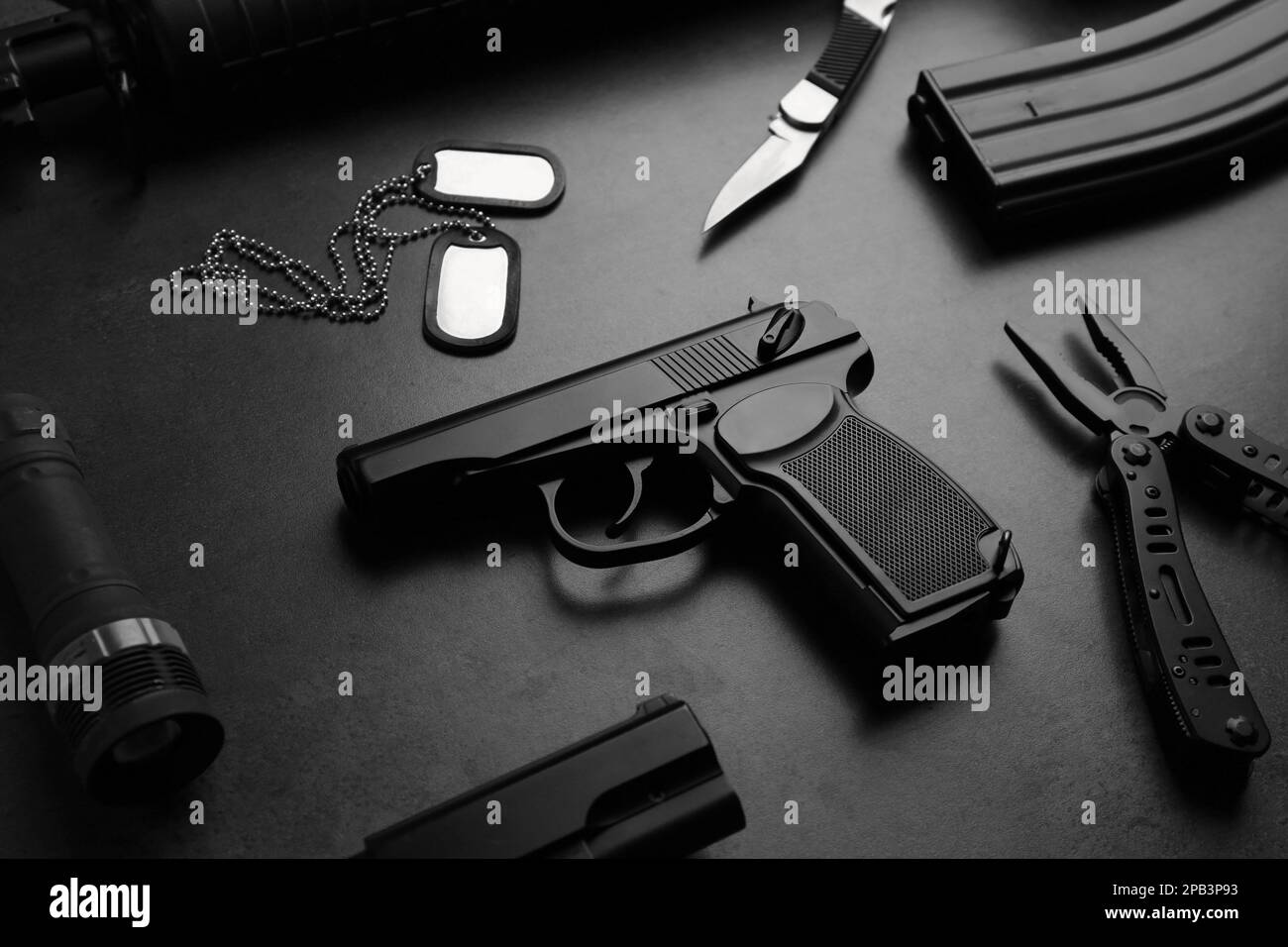 Composition with professional gun on black background Stock Photo - Alamy