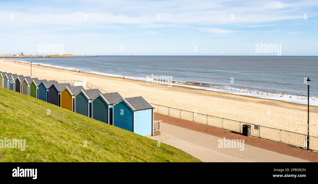 Colourful beach huts on the promenade or esplanade in the seaside town
