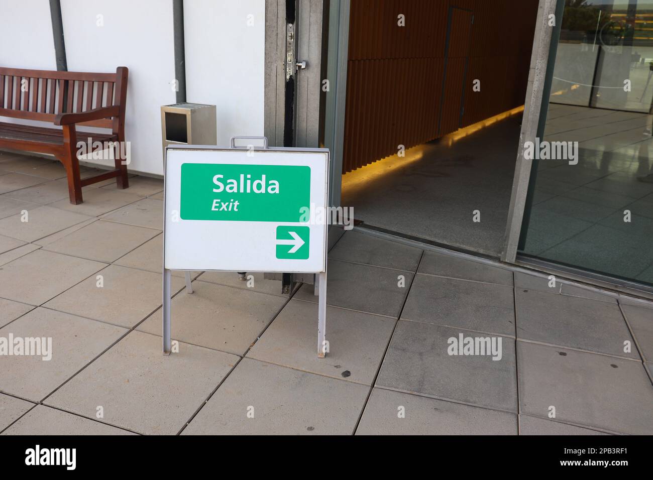 A Little Sign Board to Show Exit Way Both in English and Spanish