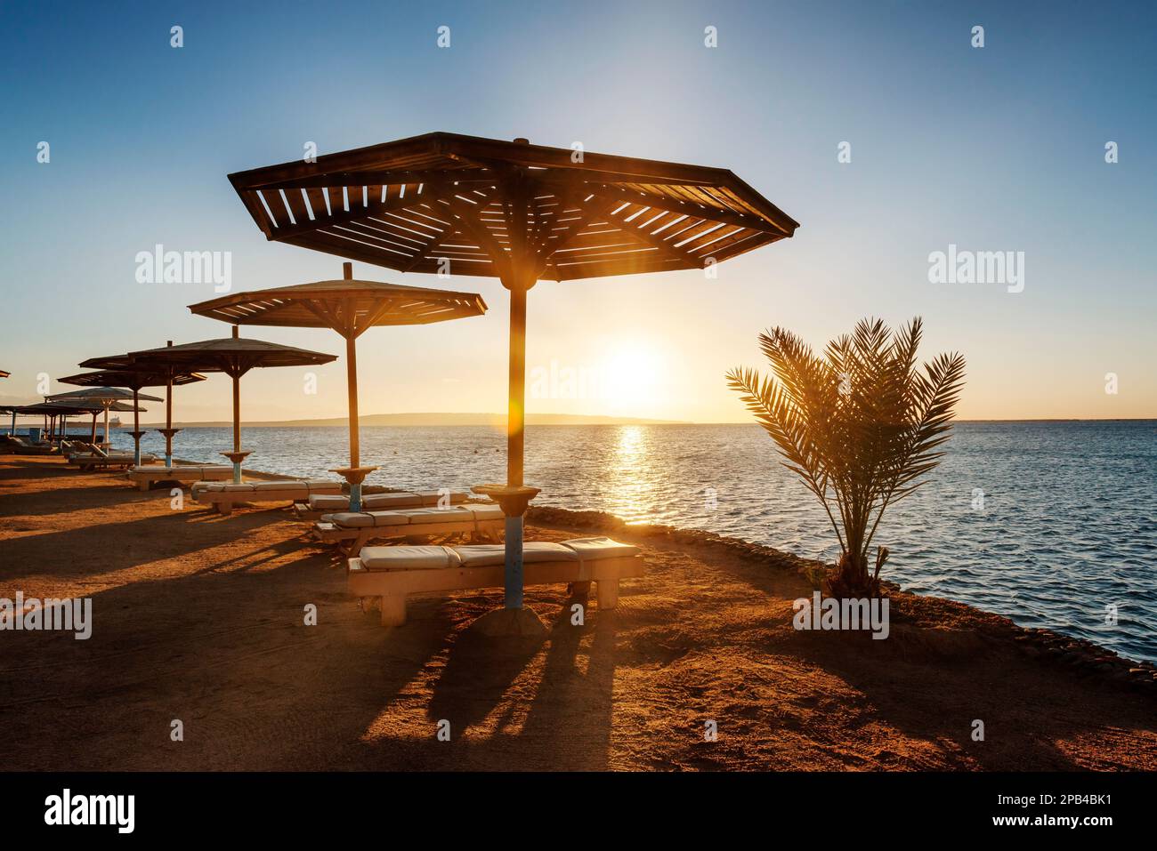 Amazing sunrise on an empty beach, a resort on the Red Sea Stock Photo