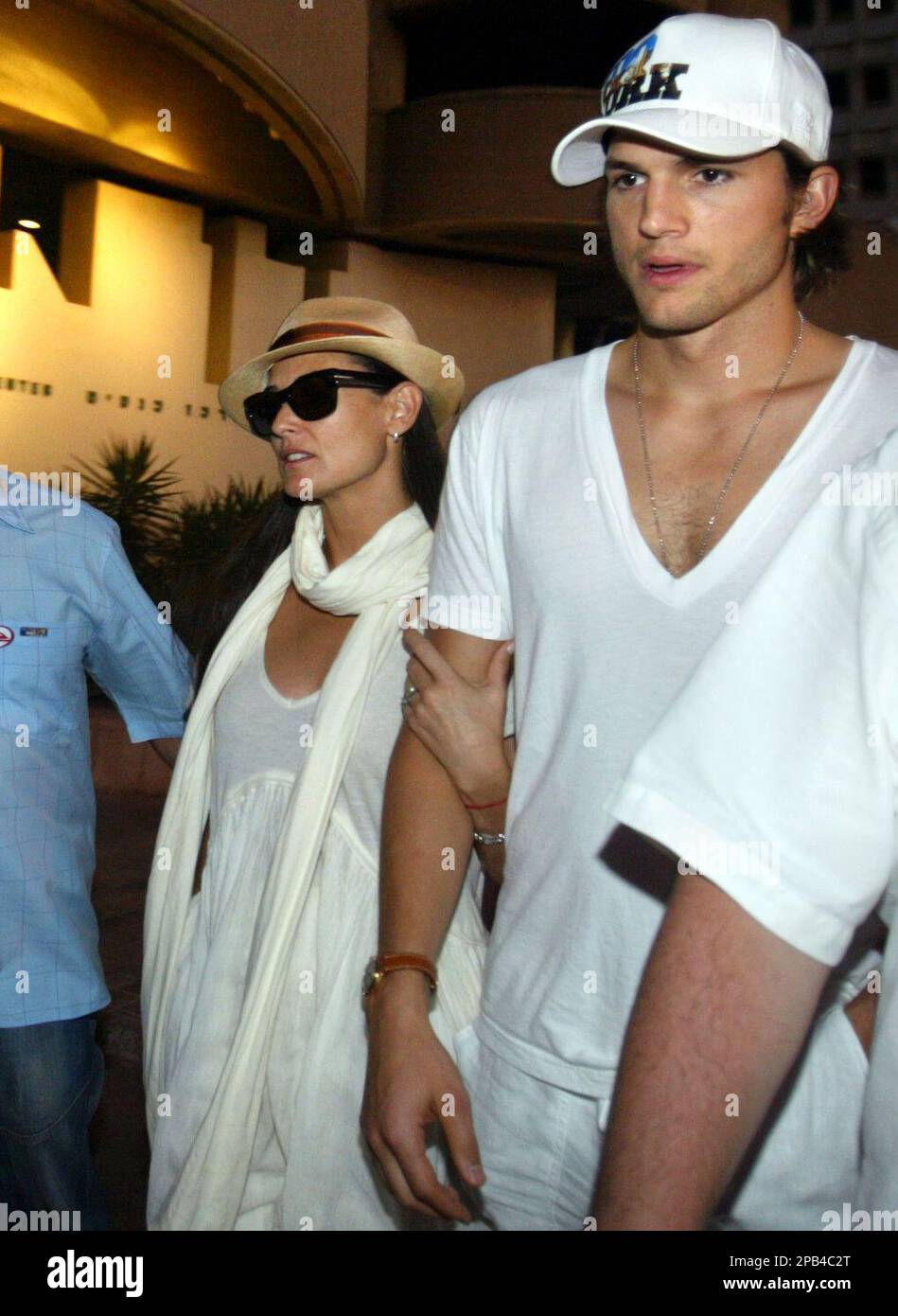 American actress Demi Moore and husband Ashton Kutcher, right, walk out