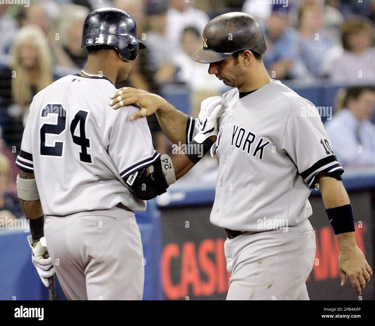 New York Yankees' Robinson Cano, left, congratulates Jorge Posada on ...