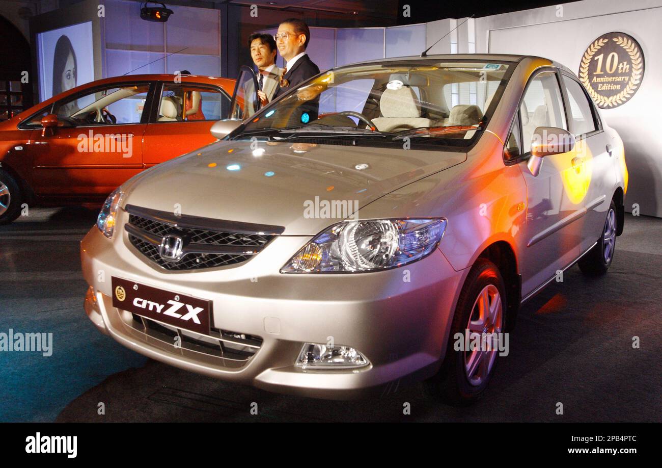 Honda Siel Cars India Ltd. President Masahiro Takedagawa, center