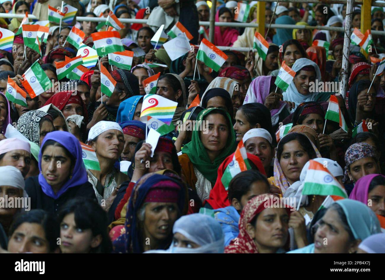 Kashmiri Muslim women hold the Indian national flag as they attend a ...