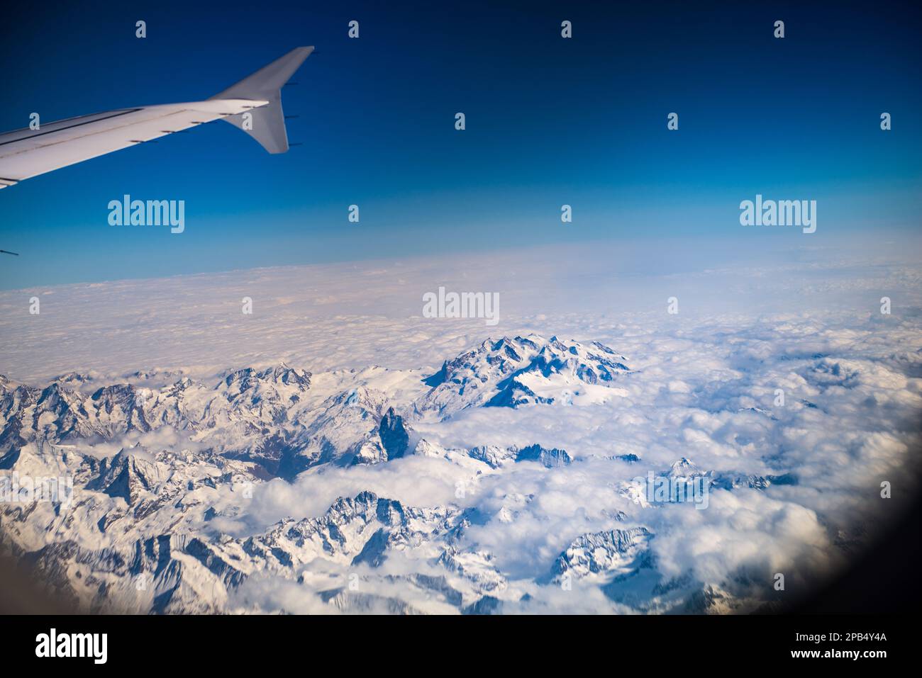 View of the swiss alps through an airplane window Stock Photo