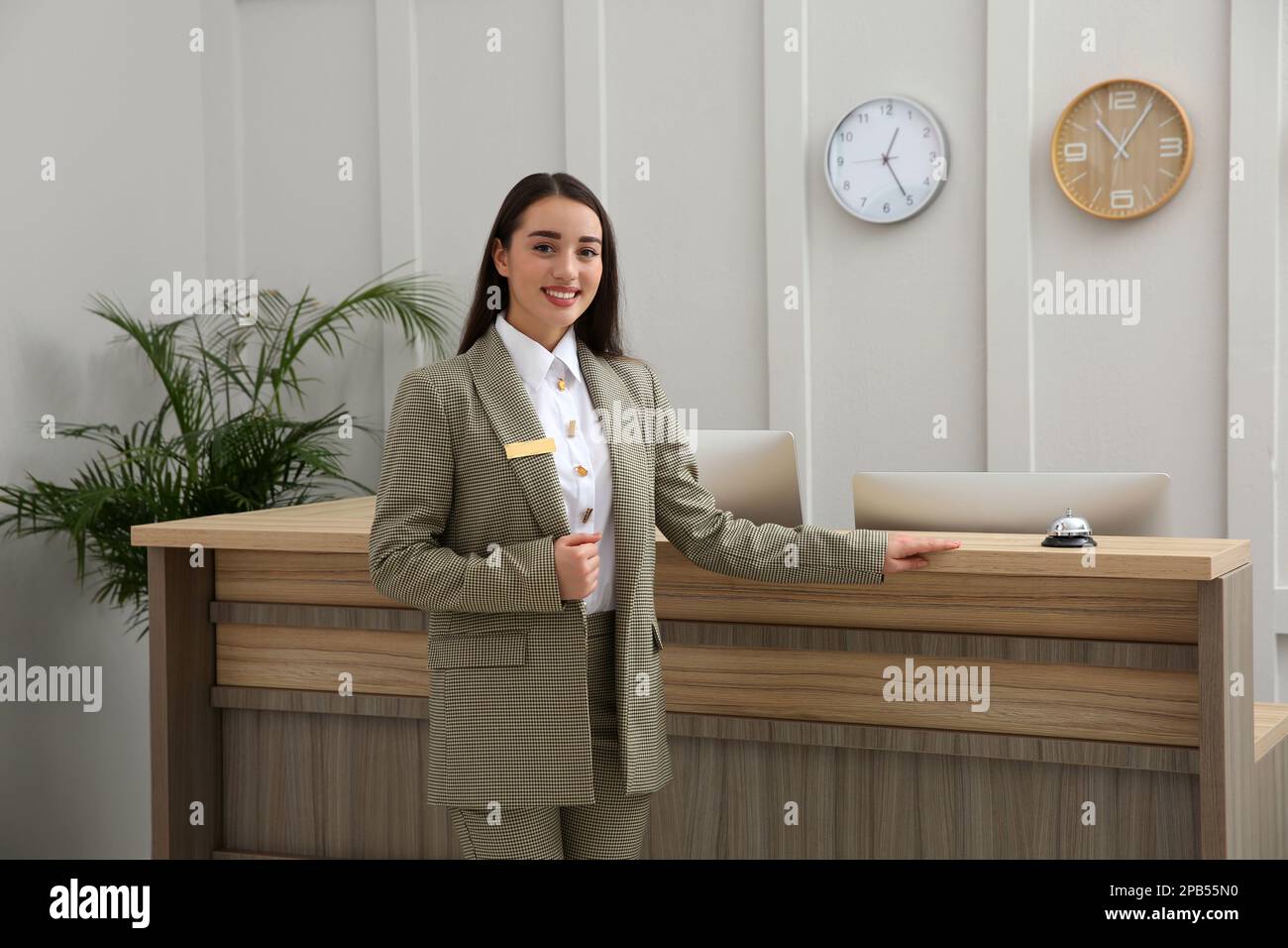 portrait-of-beautiful-receptionist-near-counter-in-hotel-stock-photo