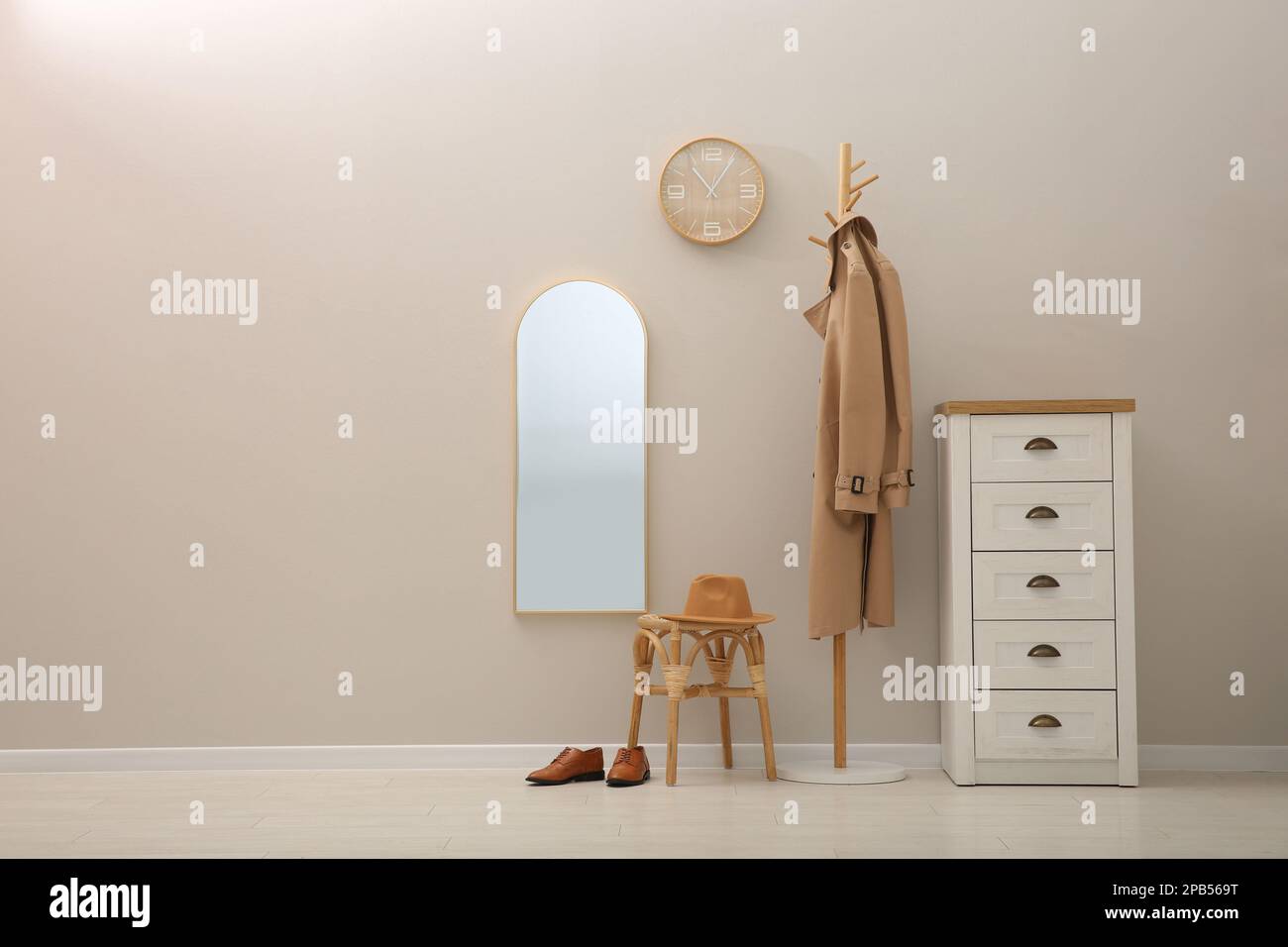 Hallway interior with wooden furniture near light wall. Stylish accessories Stock Photo