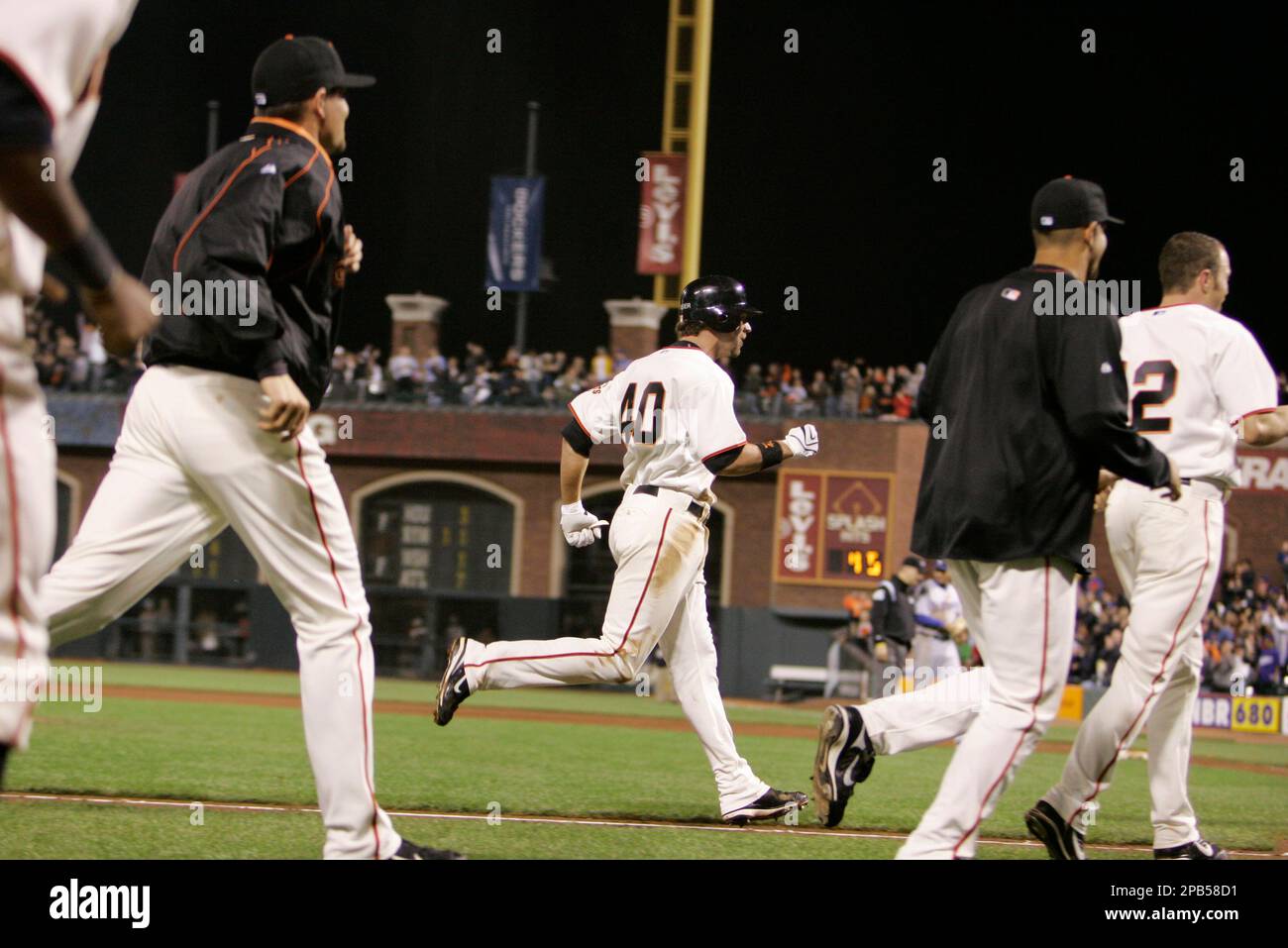 San Francisco Giants' Daniel Ortmeier, center, runs for home plate and ...
