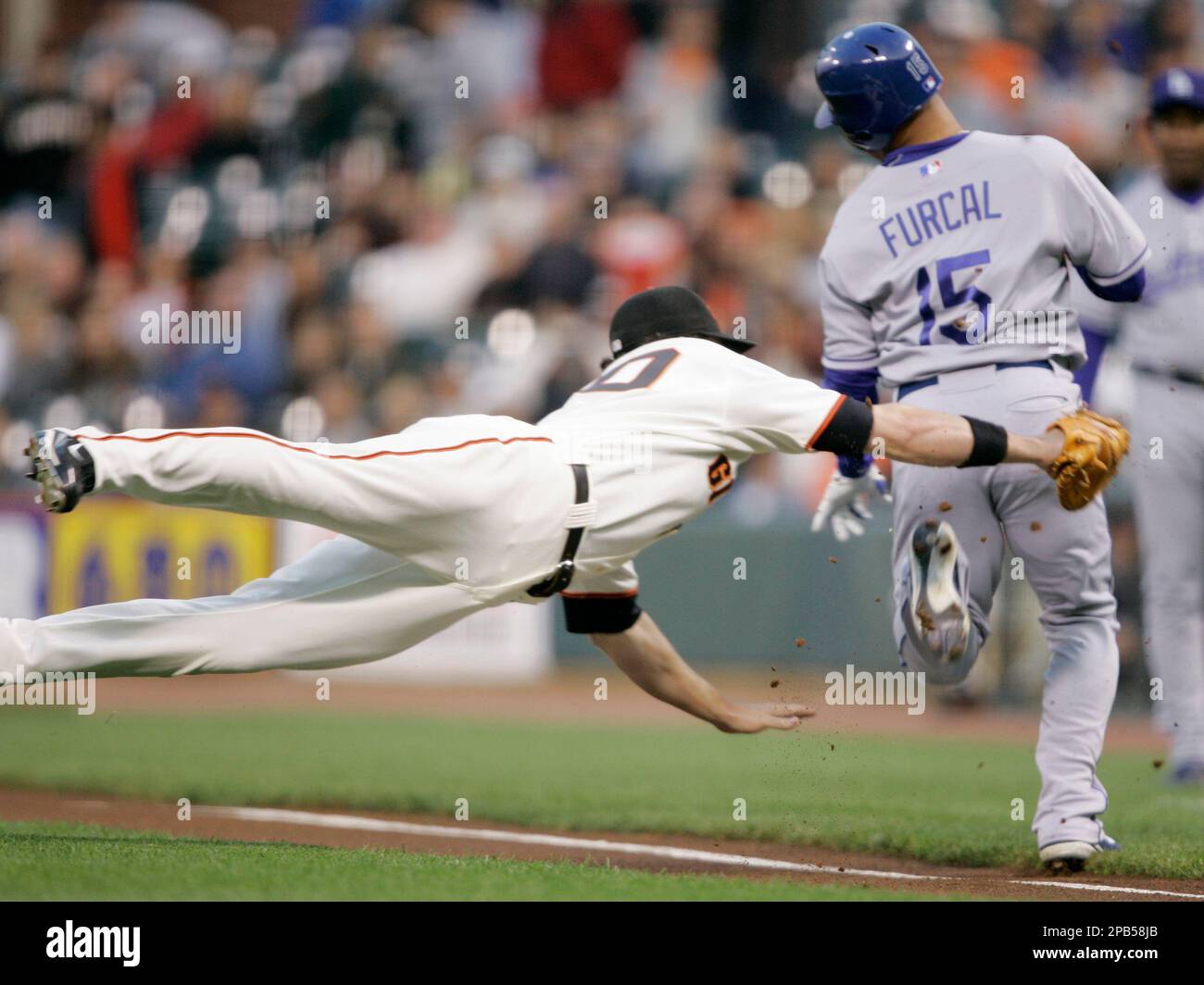 San Francisco Giants first baseman Daniel Ortmeier, left, dives and ...