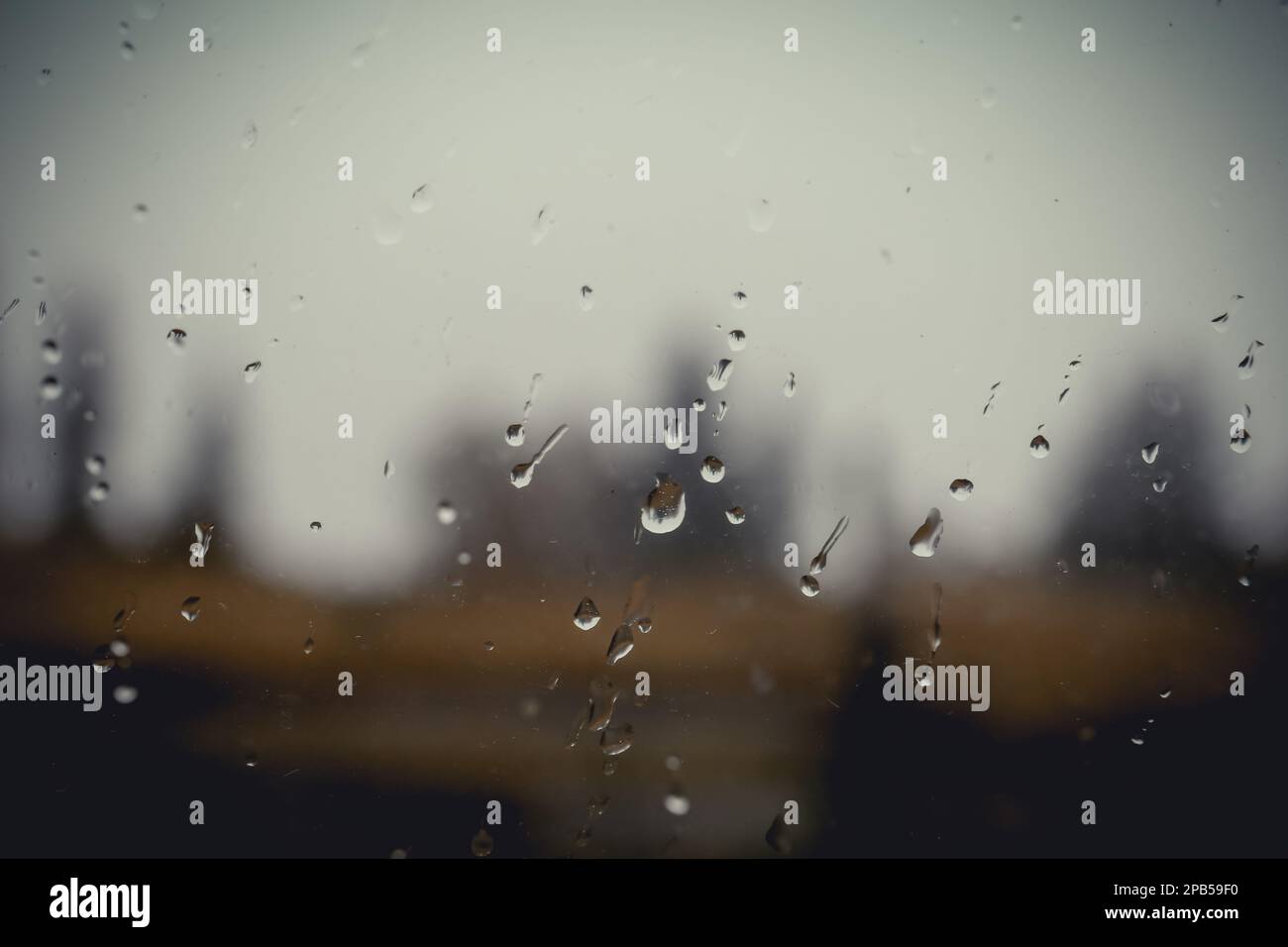 Blurred view through wet window on rainy day Stock Photo - Alamy