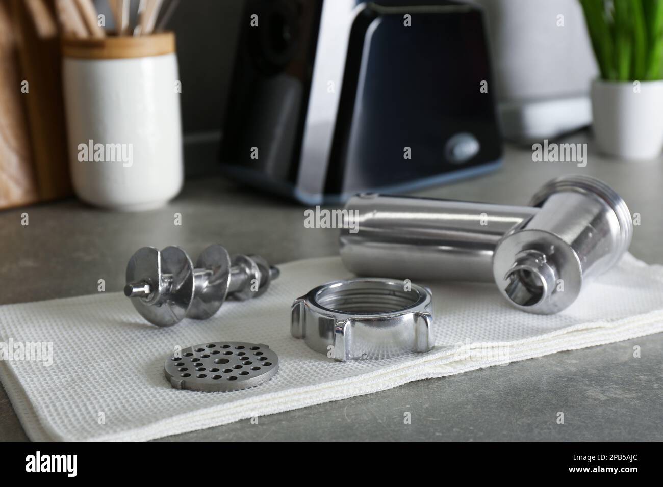 Clean parts of electric meat grinder on grey table indoors Stock Photo
